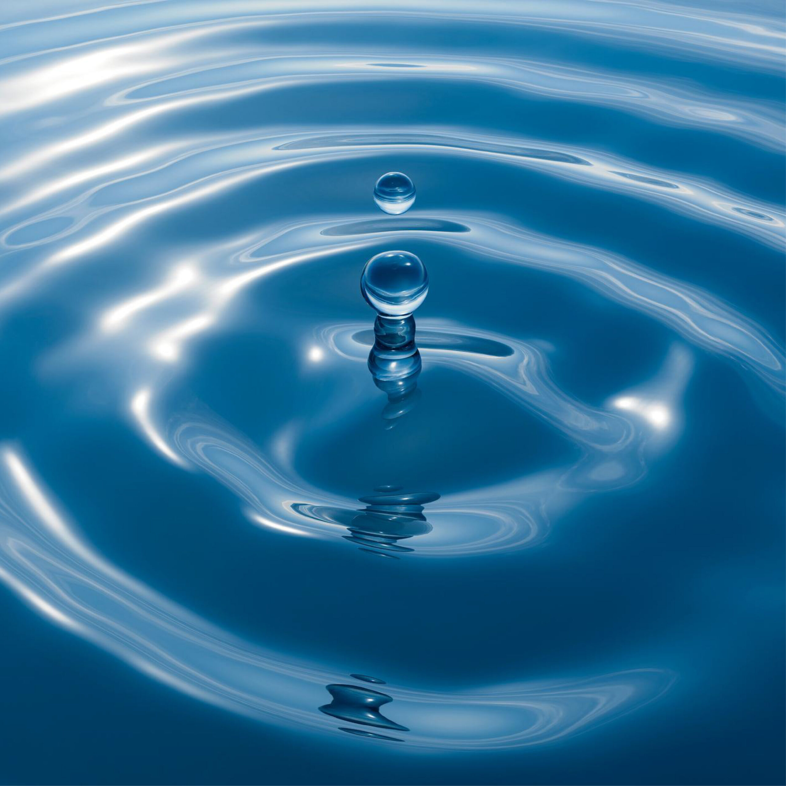 Drop of water creating ripples.
