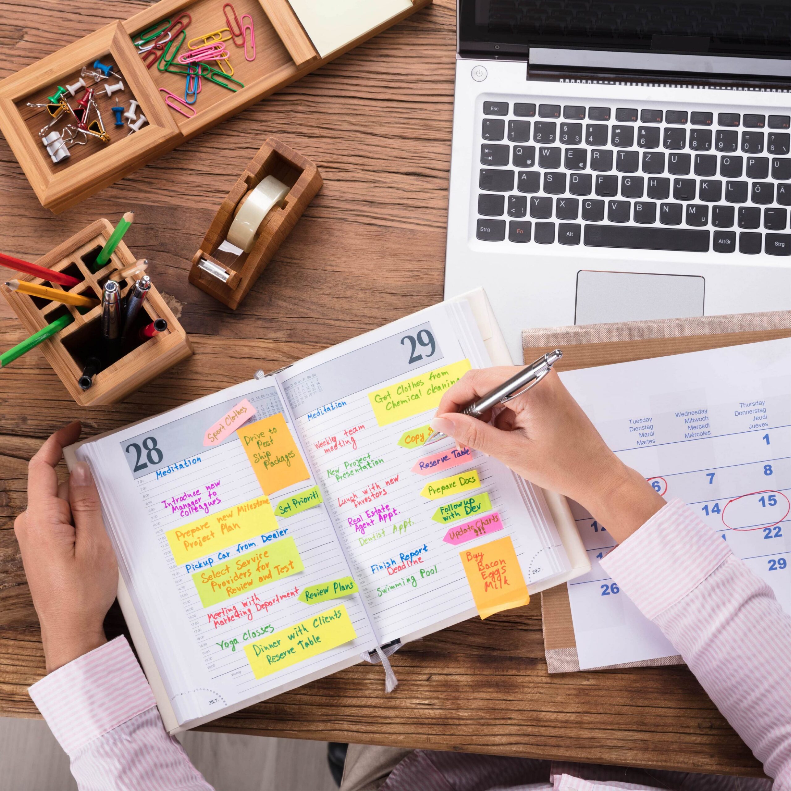 Woman navigating the divorce process writing in a planner, surrounded by office work supplies.